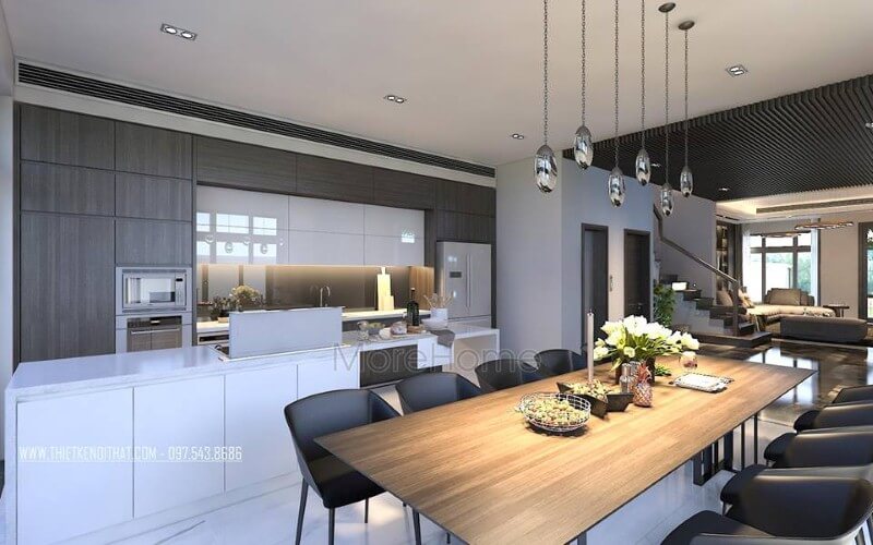 Bàn ăn gỗ nguyên tấm mộc mạc kết hợp đồ nội thất hiện đại sẽ là lựa chọn ấn tượng tạo nên không gian độc đáo cho phòng ăn liền bếp. Thiết kế phòng ăn biệt thự